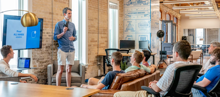A group of people in a casual office setting attending a presentation